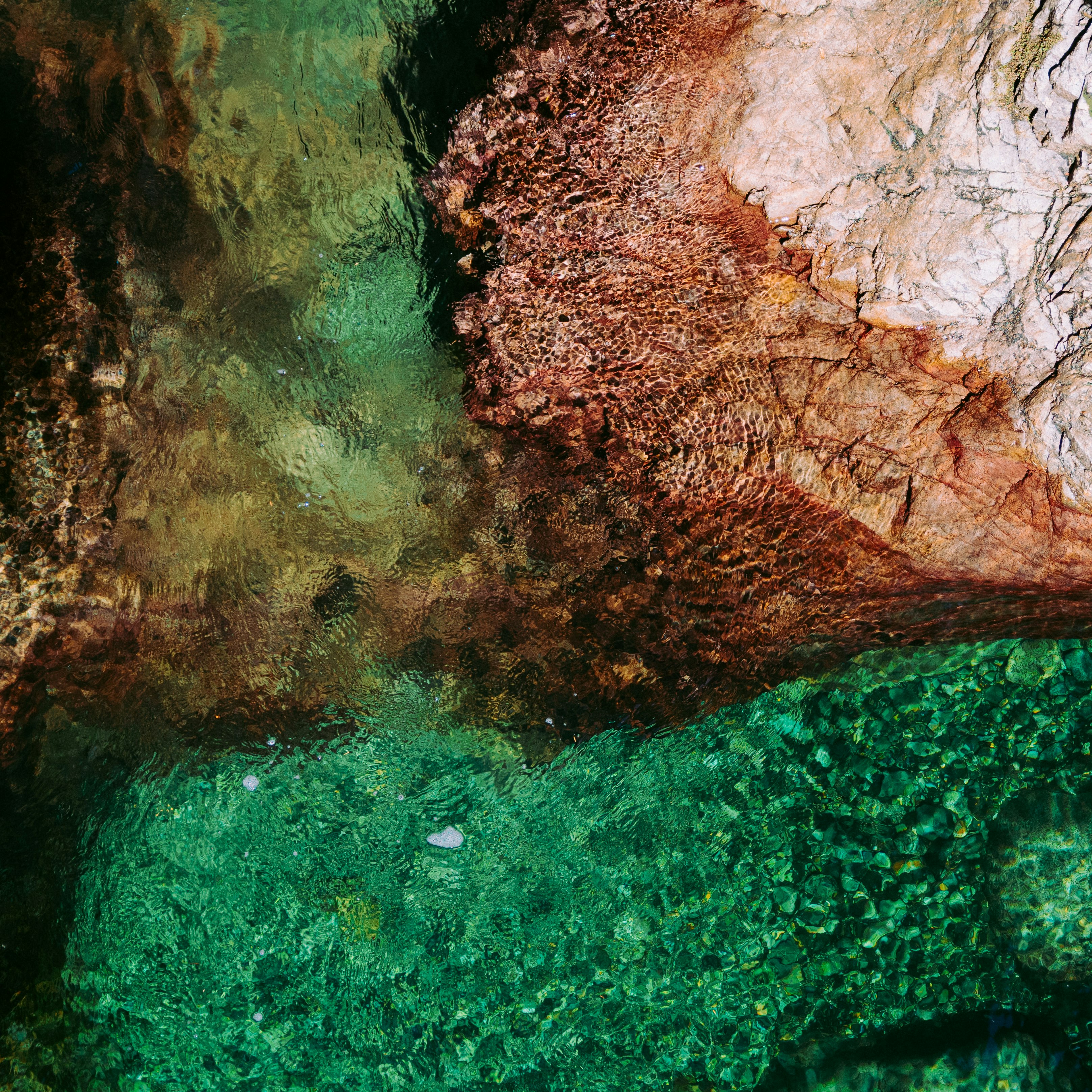 aerial photography of body of water and rock